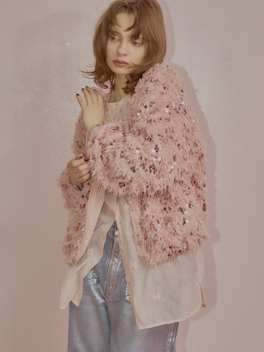 スパンコールフェザーカーディガンとリボン刺繍シアーシャツと箔ストレートデニムパンツを着用した女性の画像